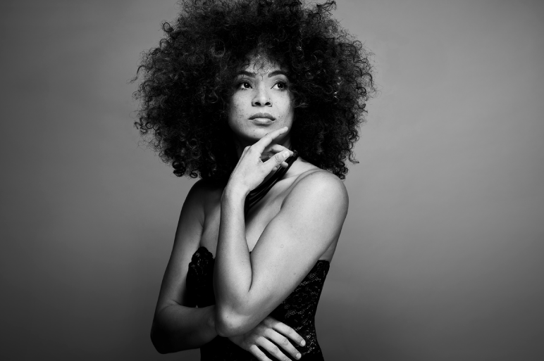 Kandace Springs poses with a hand under her chin