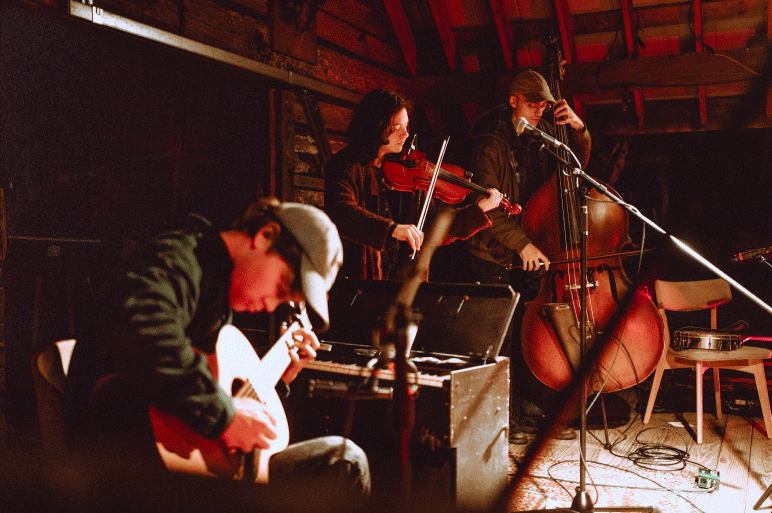 Members of Magic Tuber Stringband play instruments