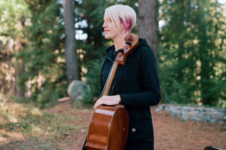Zoë Keating holds the cello and looks to the side